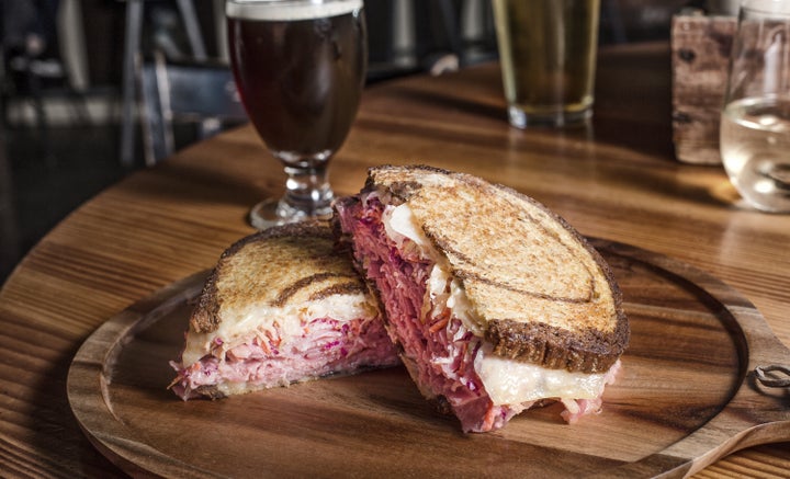 A sandwich that pairs well with beer: corned beef, juniper berry sauerkraut, Swiss and purple slaw slathered with Sriracha Russian dressing and piled onto marble rye.