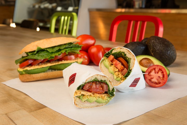 A naturally vegetarian (but completely satisfying!) sammie with a stack of avocado, tomatoes, a parmesan crisp, lettuce, and oil and vinegar on a torpedo roll.