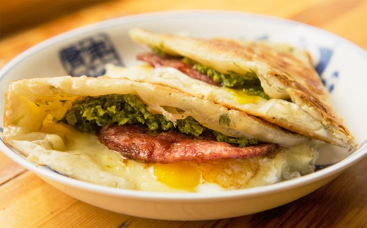 Mei Mei's Double Awesome: an herbaceous, savory, handheld scallion pancake smothered in a local greens pesto and filled with two soft eggs and Vermont cheese. 