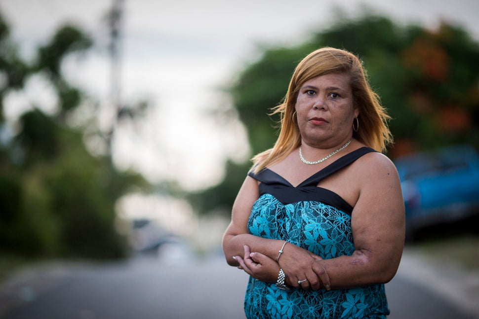 Rivera Acosta stands outside of her home in Vieques. The mother of two said the long journey to the main island for treatment