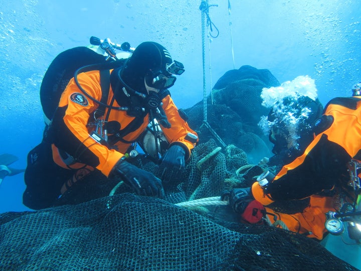 Divers from Ghost Fishing work to recover a massive fishing net abandoned a decade ago off the coast of the Aeolian Isla