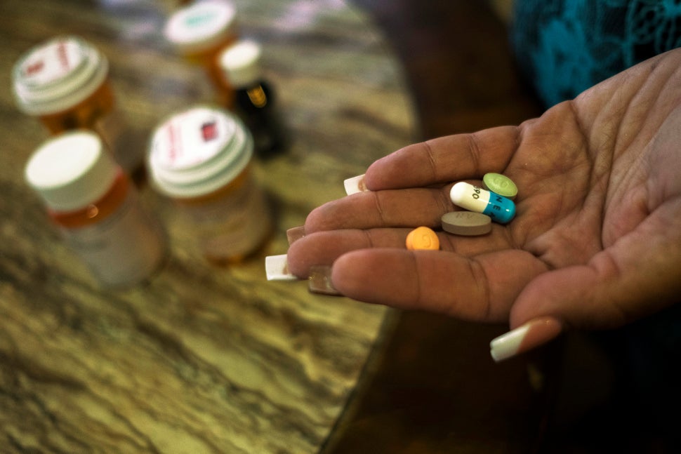 In her home, Rivera Acosta takes medication for her kidney failure and hypertension. 