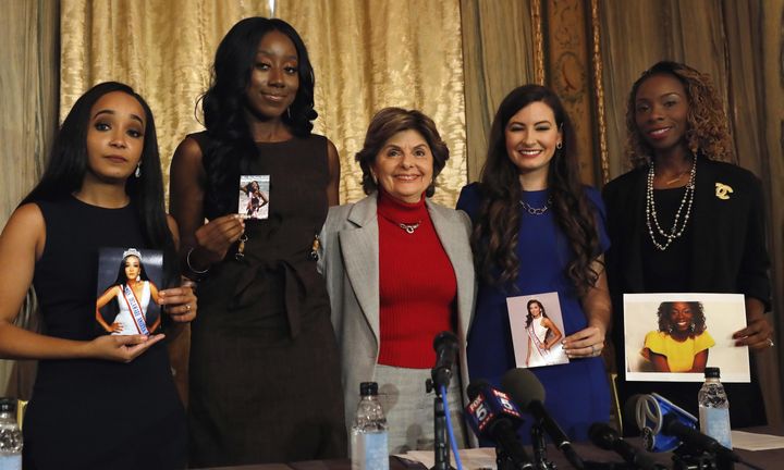 The four contestants in this year’s Mrs. America pageant surround lawyer Gloria Allred, center. Kimberly Phillips, left, Crissy Timpson, Brandy Palacios and Jeri Ward have accused the pageant’s director of making racially insensitive and demeaning remarks.