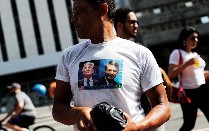 A supporter of Brazilian presidential front-runner Jair Bolsonaro wears a T-shirt twinning with the candidate's image with that of U.S. President Donald Trump.