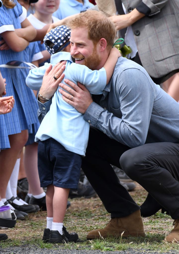 Prince Harry hugs five-year-old Luke during his first royal tour with Meghan Markle. 