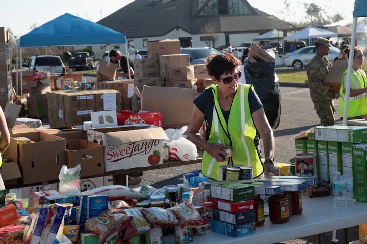 Volunteers help distribute food, water, cleaning supplies and other necessities to victims of Hurricane Michael at an aid dis