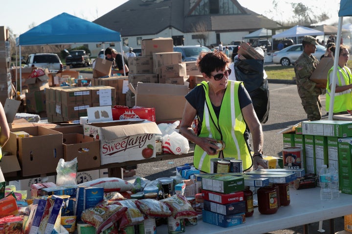 Volunteers help distribute food, water, cleaning supplies and other necessities to victims of Hurricane Michael at an aid distribution point on October 15, 2018 in Panama City, Florida. 