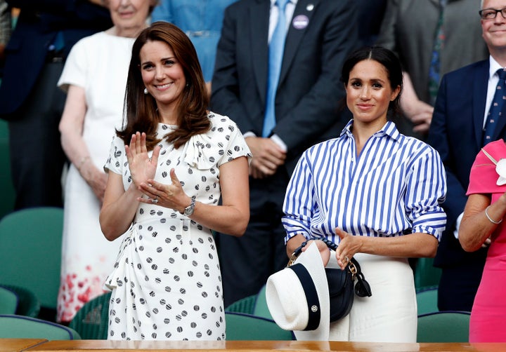 The Duchess of Cambridge and the Duchess of Sussex applaud in the royal box after the Wimbledon Championships ladies' singles final on July 14, 2018.