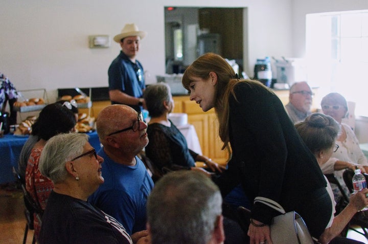 Oliver talking to attendees at a town hall campaign event in Texas.