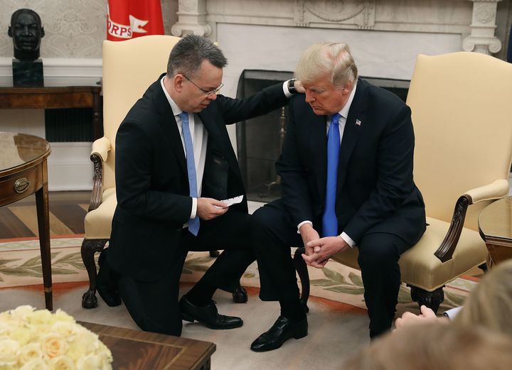 President Donald Trump prays with American pastor Andrew Brunson in the Oval Office of the White House on Oct. 13, 2018.
