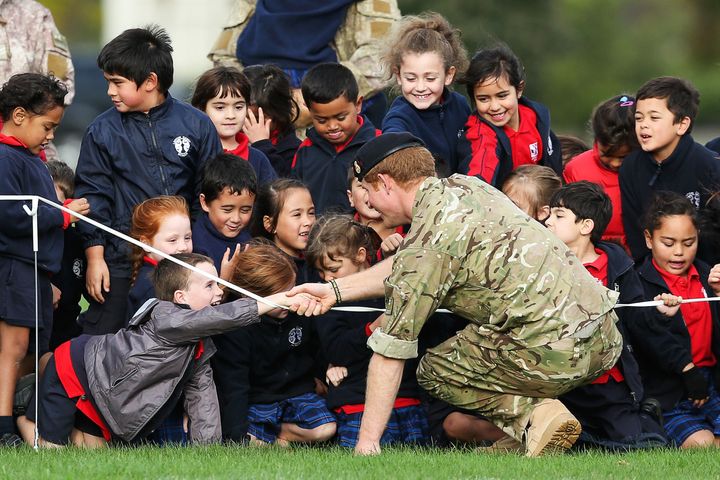Prince Harry speaks to a group of children during a visit to Linton Military Camp on May 13, 2015 in Palmerston North, New Zealand. 