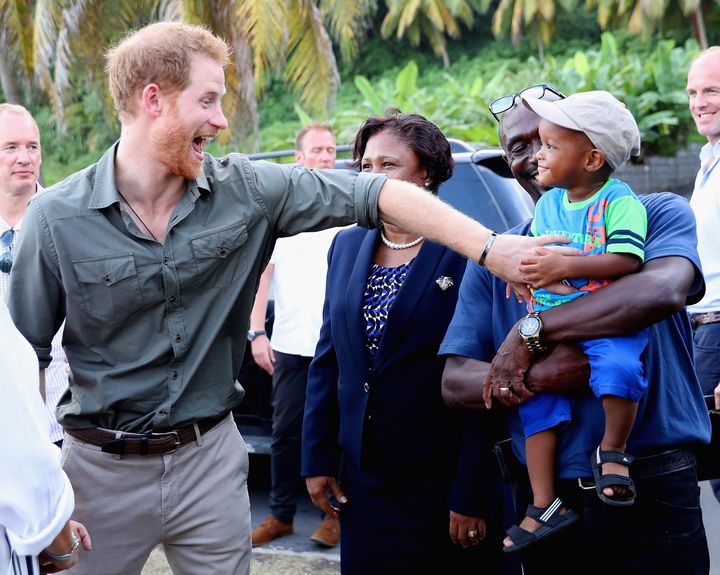 Prince Harry meets a young boy called Jyasi Junior as he visits a Turtle Conservation Project on the seventh day of an official visit to the Caribbean on November 26, 2016 in Colonarie, Saint Vincent and the Grenadines. 