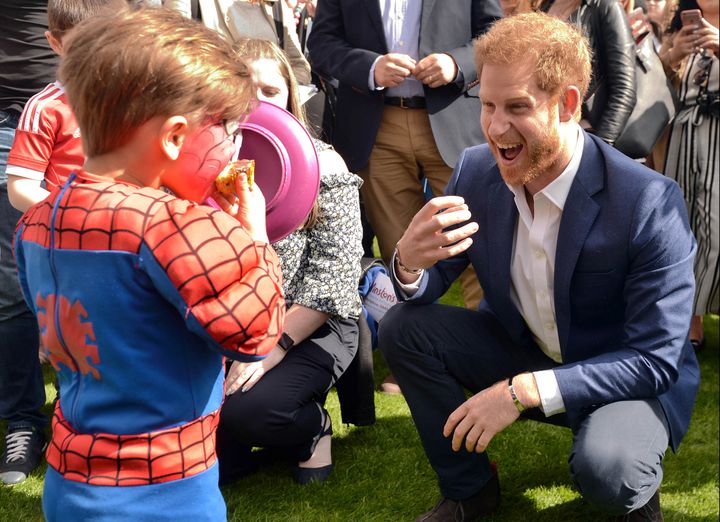 Prince Harry plays George Hinchliffe 3 (dressed as spiderman) as he hosts a tea party in the grounds of Buckingham Palace to honour the children of those who have died serving in the armed forces on May 13, 2017 in London, England. 