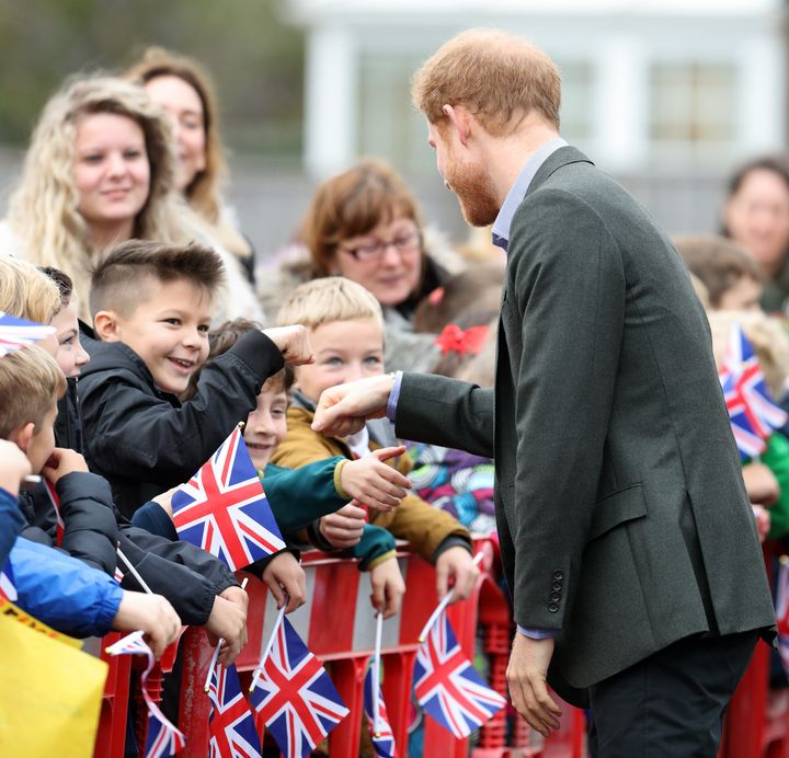 Prince Harry fist bumps schoolchildren as he visits St Michael's on Wyre village hall on October 23, 2017 in St Michael's on Wyre, England. 