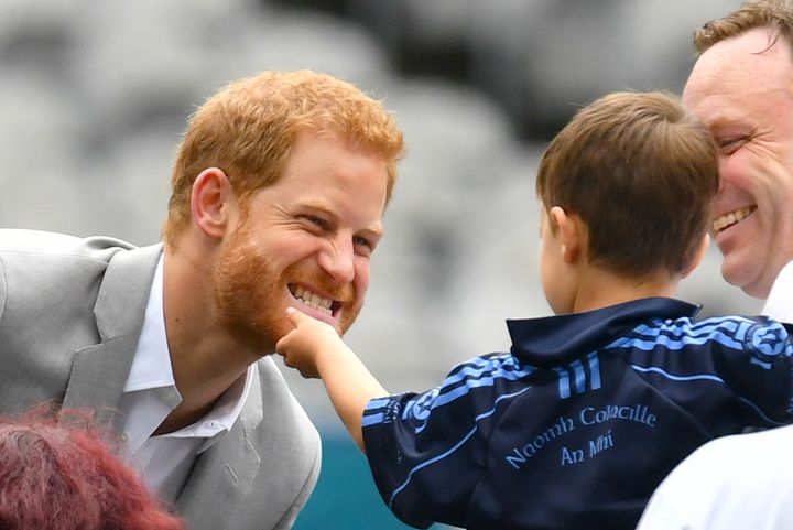 Prince Harry has a young boy ruffle his beard while on a royal visit earlier in 2018. 