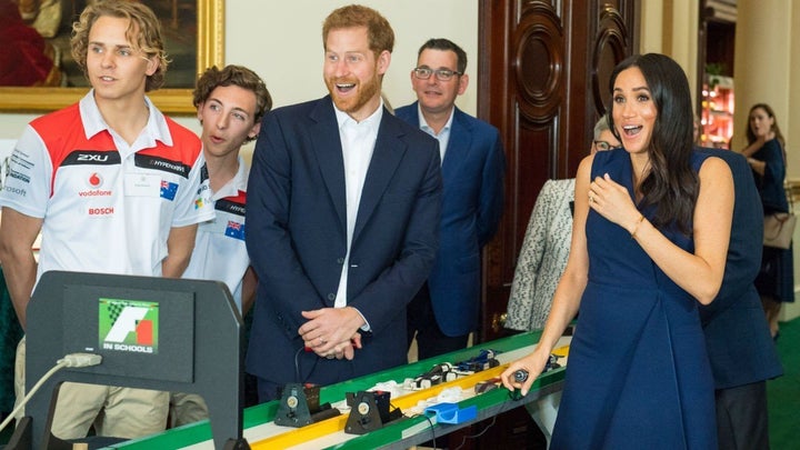 The Duchess of Sussex reacts after the big bang to start the students' mini-Formula 1 racing demonstration.