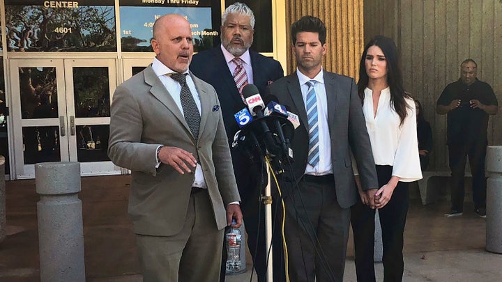 Reality show doctor Grant Robicheaux, second from right, and his girlfriend Cerissa Riley, right, listen as Robicheaux's attorney speaks. 