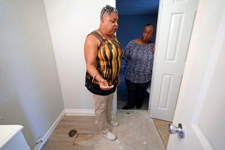 In this Aug. 9, 2018, photo, Shirley Paley, left, talks about surviving through Hurricane Harvey as she stands inside her home, which is being repaired from flood damage.