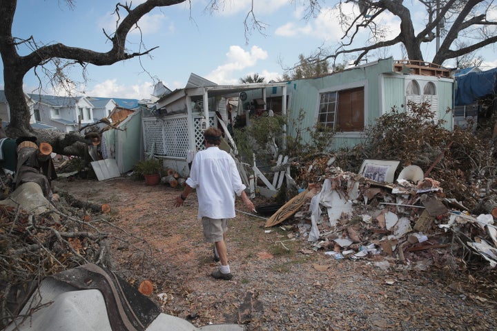 Debbie Powell of Panama City, Florida, walks to her trailer on Oct. 15 in Water's Edge RV Park, which was damaged by Hurricane Michael.