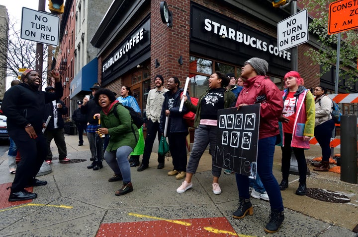 People protest a Philadelphia Starbucks after an employee called the police on two black men sitting in the restaurant.