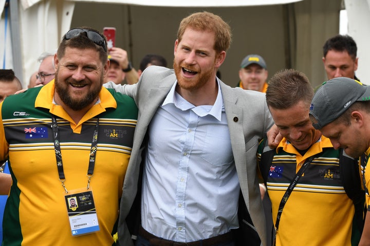 Prince Harry embraces participants in the Invictus Games Sunday morning as wife Meghan Markle took a break.