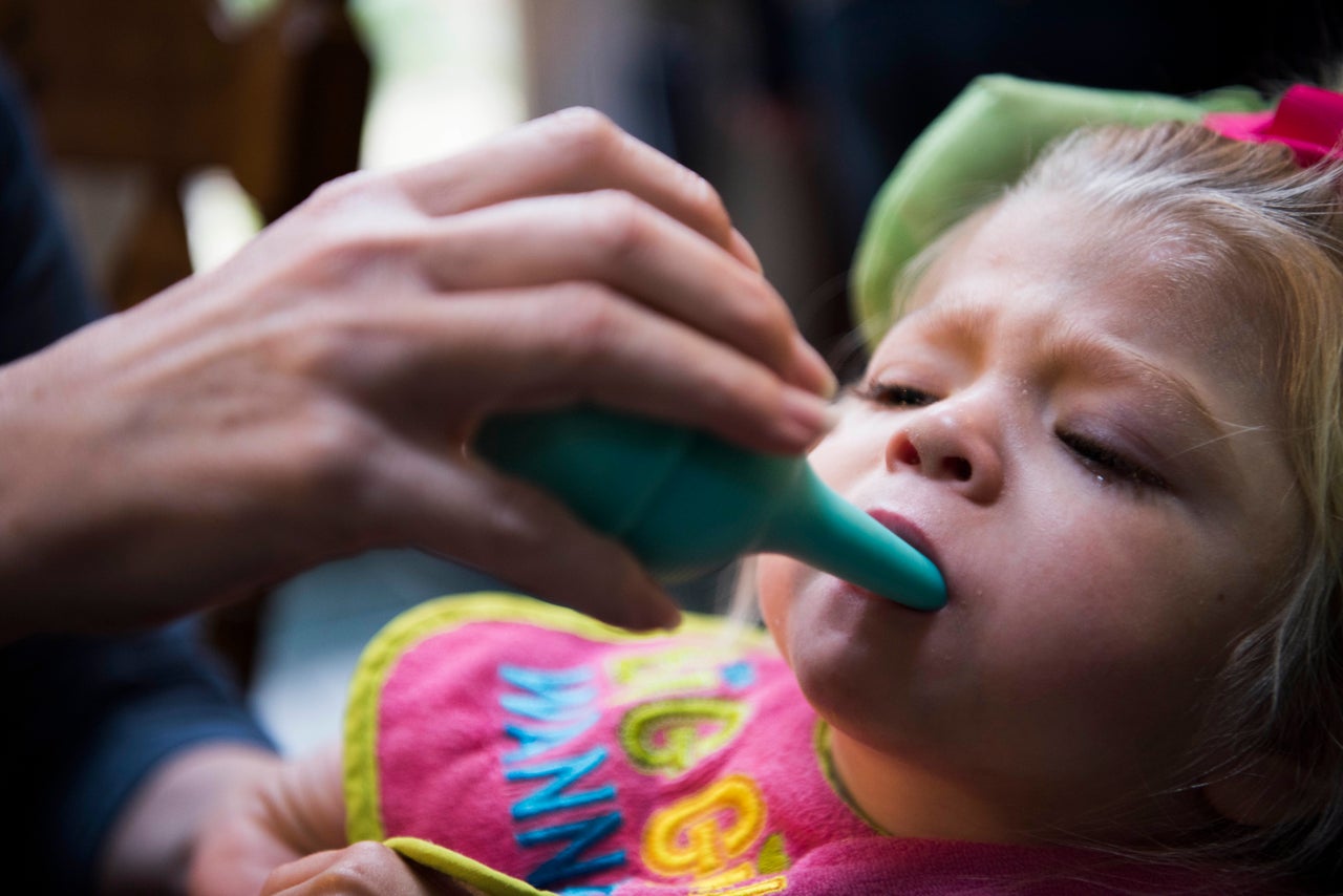 As Willow chokes on her own saliva, Glenda uses a suction tool to clear the girl's airway so she can breathe.