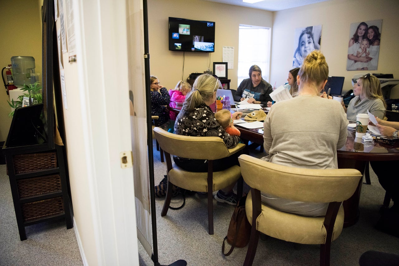 Amber runs a meeting at her office with United MSD Foundation volunteers to plan "The Zebra Run," a 5K race to help raise funds.