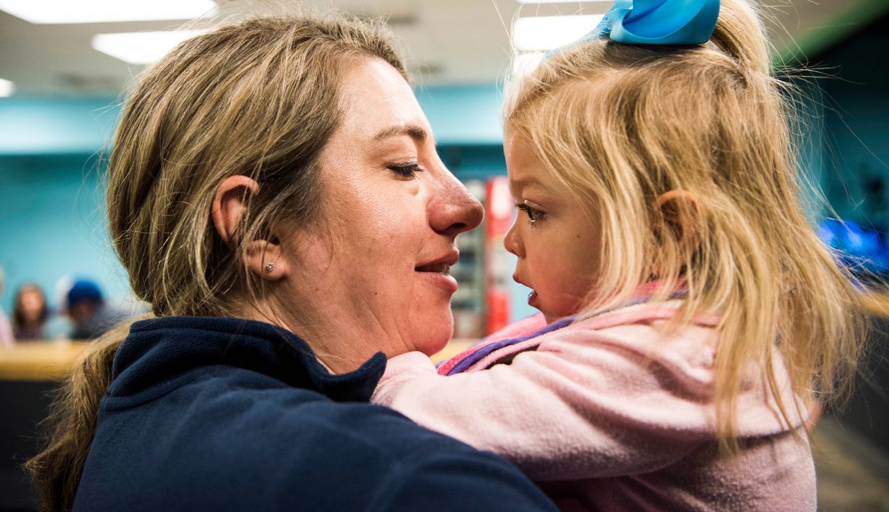 Amber Olsen holds her daughter Willow Cannan, who has multiple sulfatase deficiency, before they go roller skating.