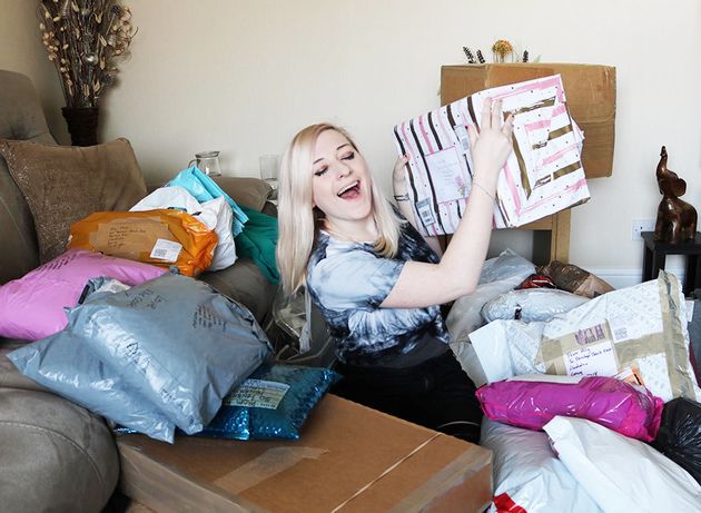 Ally surrounded by packaged up dresses ready to be sent out to girls around the UK. 