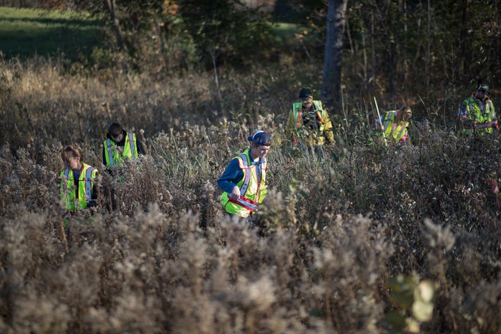 Volunteers search for evidence in the woods and fields near Jayme Close's home in Barron, Wisconsin.