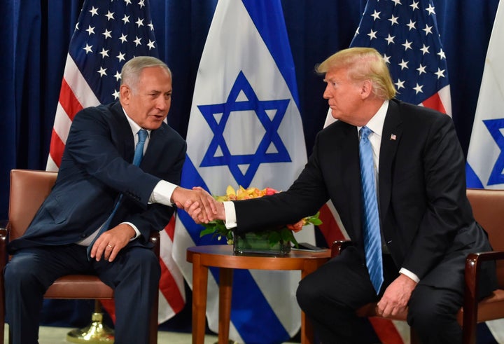 President Donald Trump shakes hands with Israeli Prime Minister Benjamin Netanyahu.