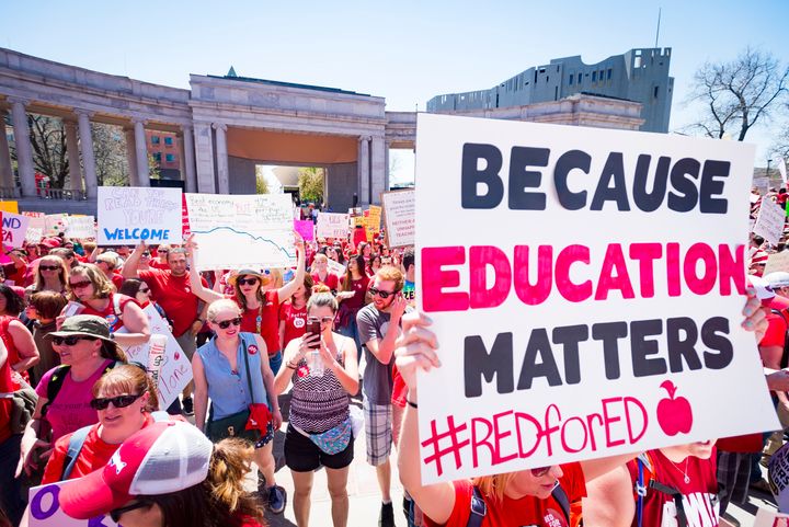 A sign reads "Because education matters, #redfored" as thousands of teachers and supporters begin their rally from the amphitheater at Civic Center Park in Denver, Colorado, on April 27, 2018.