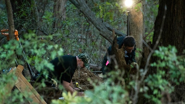 In this Monday, Oct. 22, 2018 photo, detectives investigate the scene where remains believed to be those of a southwestern Michigan woman who disappeared in 2010 were found, in Fulton, Mich. Doug Stewart, who was convicted of killing his estranged wife in 2011, took police to the burial site Monday. (Daniel Vasta /Kalamazoo Gazette via AP)