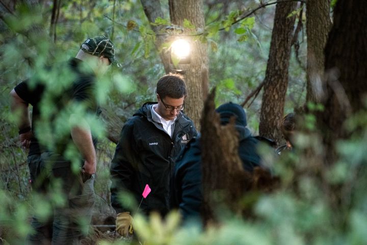 In this Monday, Oct. 22, 2018 photo, detectives investigate the scene where the remains of a southwestern Michigan woman who disappeared in 2010 were found.