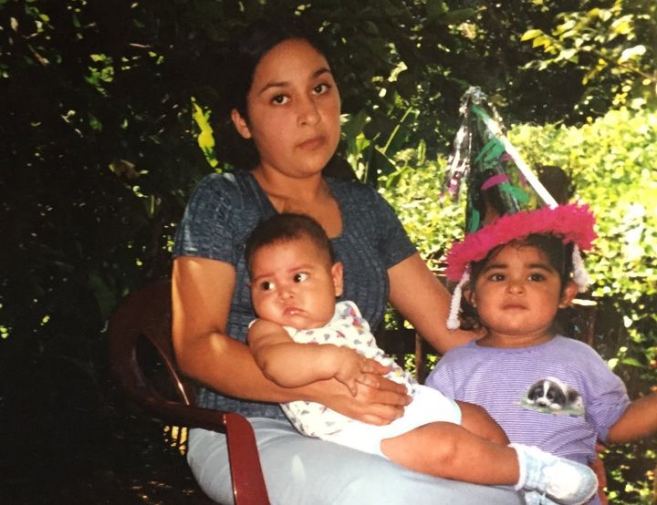 Idalia Majano-Amaya, now a TPS recipient, sits with her two eldest children, Sam and Diana Amaya, in El Salvador in the early 2000s.