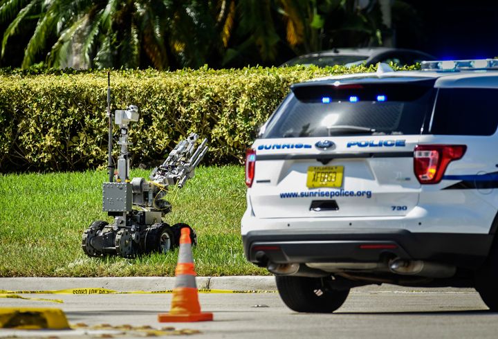 A bomb defusing robot is sent into the Sunrise Utility Administrative Centre in Sunrise, Florida, after a suspicious package was discovered in the building where Congresswoman Deborah Wasserman Schultz's office is located.