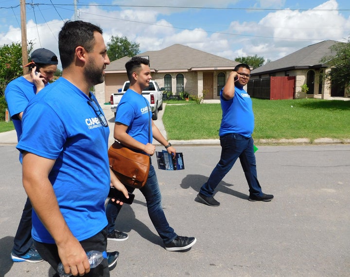 Danny Diaz, in the foreground, leads a group of canvassers to knock on the doors of a very Hispanic neighborhood of South McAl