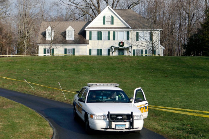 In this Dec. 18, 2012, file photo, a police cruiser sits in the driveway of the Colonial-style house where Adam Lanza lived w