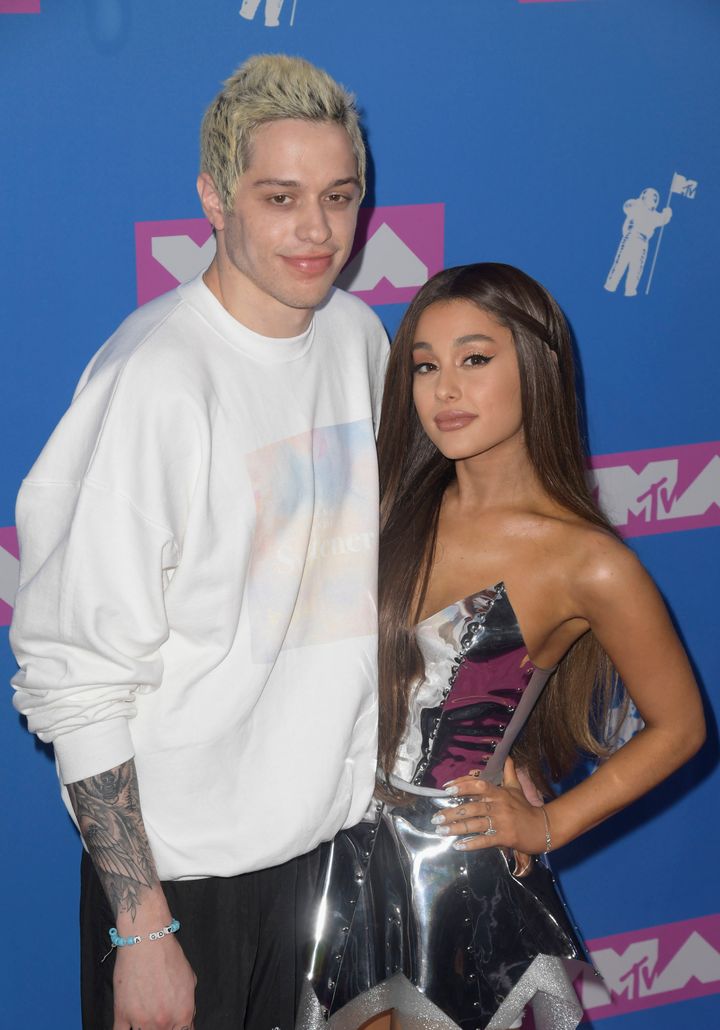 Pete Davidson and Ariana Grande pose on the red carpet. 
