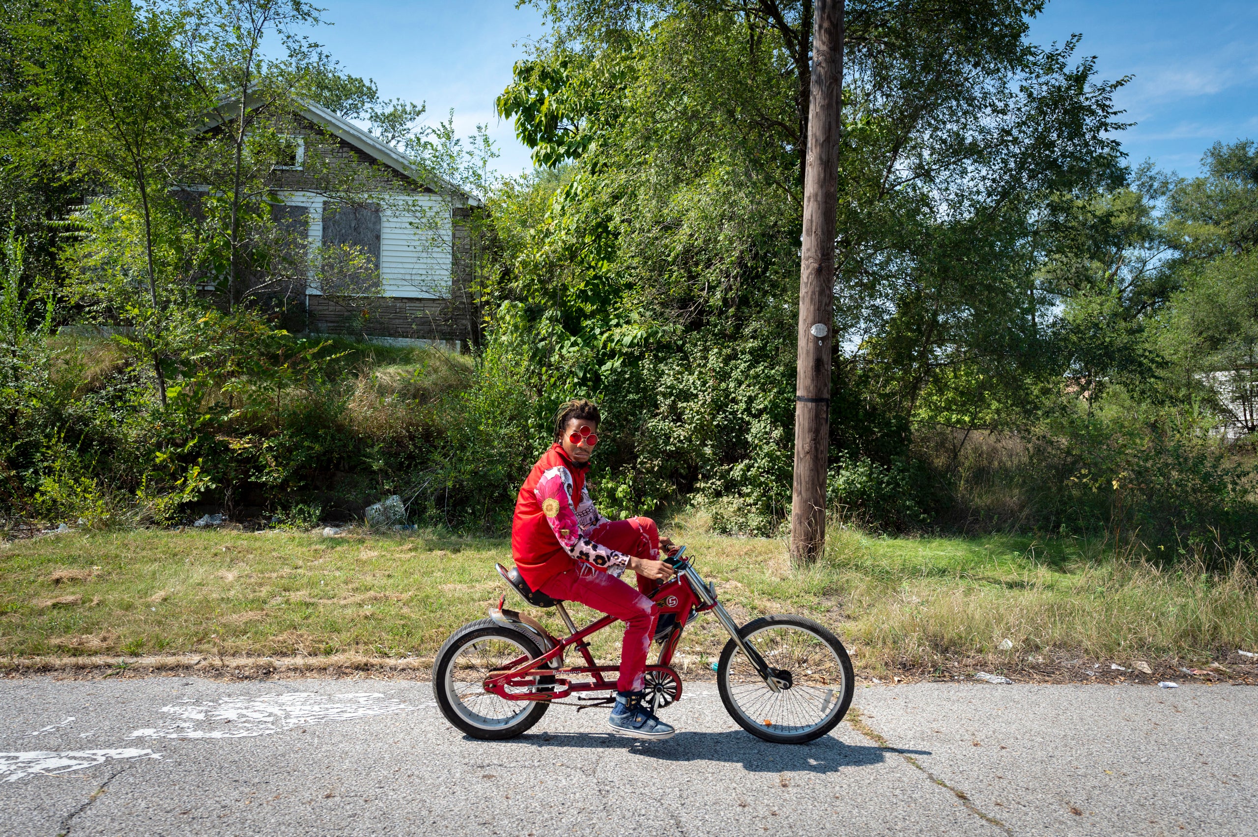 Chris Grant, a 24-year-old dancer in Gary, rides his bike through the neighborhood where he has lived for three years and whe