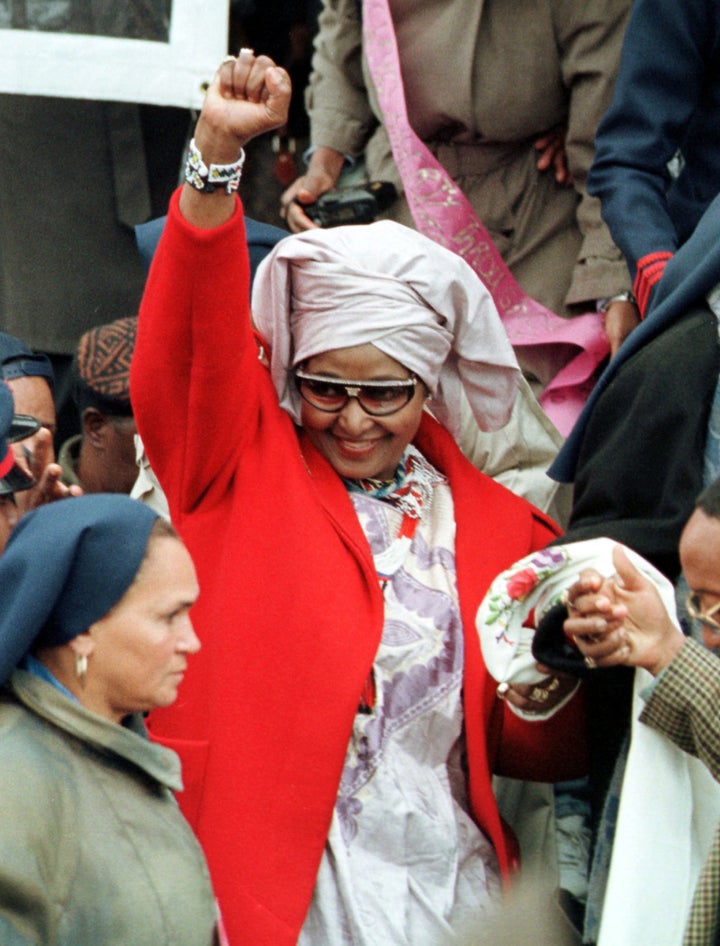 Winnie Madikizela-Mandela (former wife to Nelson Mandela) salutes the crowd with a fist as she exits the Million Woman March in 1997. 