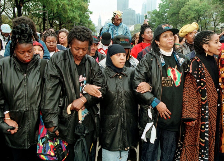 Women link arms in prayer during the 1997 Million Woman March. 