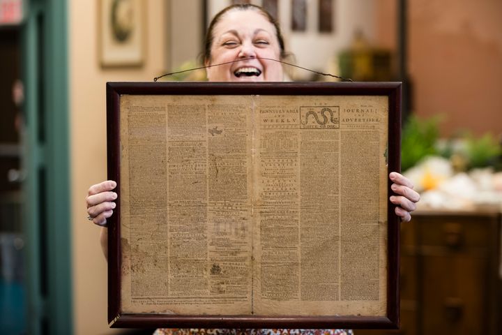 Heather Randall displays a Dec. 28, 1774 Pennsylvania Journal and the Weekly Advertiser at the Goodwill Industries South Jersey in Bellmawr, N.J., Thursday, Oct. 25, 2018. A quick eye by Goodwill workers in southern New Jersey turned up an original 1774 Philadelphia newspaper with an iconic "Unite or Die" masthead. 