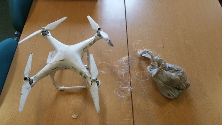 A drone with a drugs package tied to it with fishing line