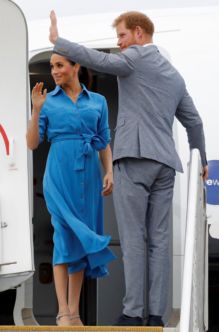 The Duchess of Sussex and Prince Harry wave goodbye before boarding their flight in Tonga.