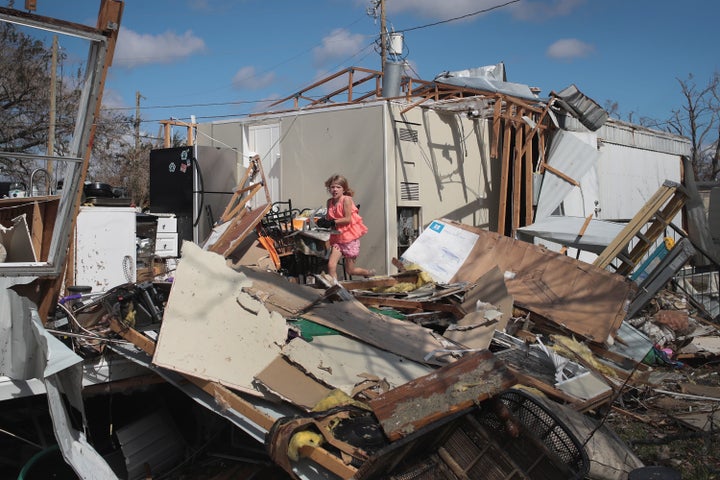 Nine-year-old Jazzmyne Brock helps her mother and grandmother salvage items from a friend's trailer after it was destroyed by Hurricane Michael at the Bay Oaks Village trailer park on Oct. 20 in Panama City, Florida.