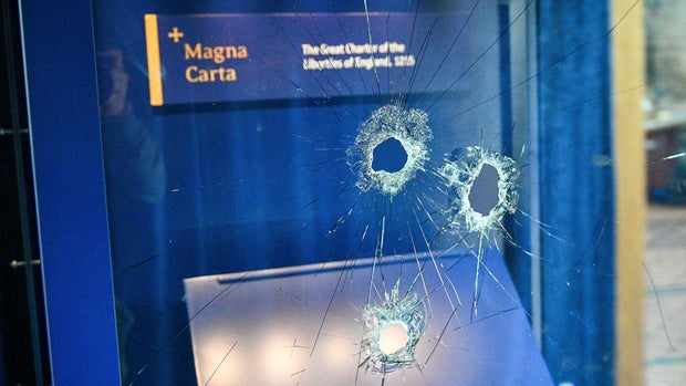 Hammer holes in the glass case that housed the Magna Carta, at Salisbury Cathedral after a 45-year-old man has been arrested on suspicion of its attempted theft, in Salisbury, England, Friday Oct. 26, 2018. British police said Friday that cathedral alarms sounded Thursday when a person tried to smash the glass display box surrounding the Magna Carta in Salisbury Cathedral, and a man has been arrested. (Ben Birchall/PA via AP)