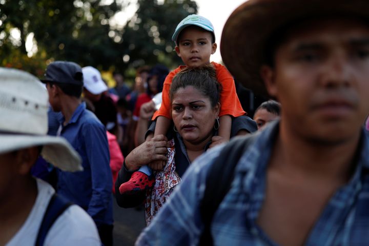 Central American migrants, part of a caravan trying to reach the U.S., walk along the road in Ciudad Hidalgo, Mexico.