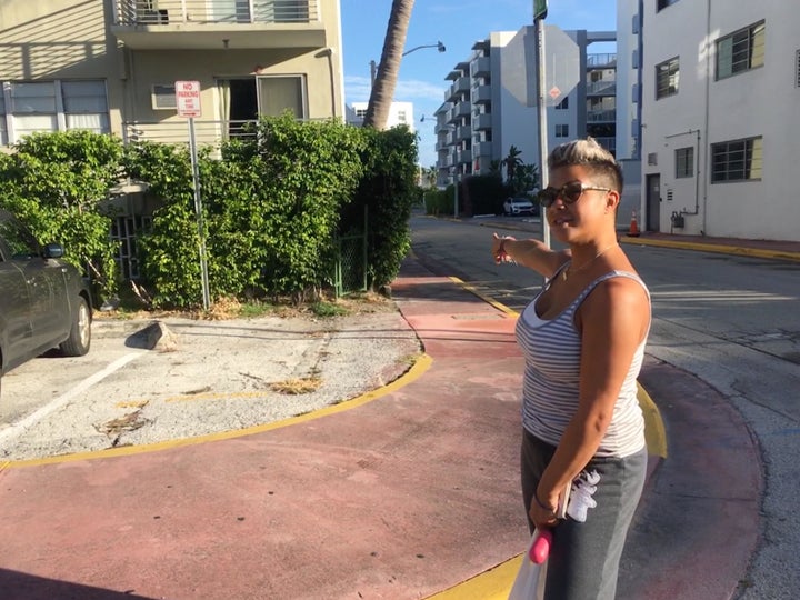 Miami Beach resident Michelle DeLeon points to where the "king tide" floods enter the parking garage beneath her building every autumn.