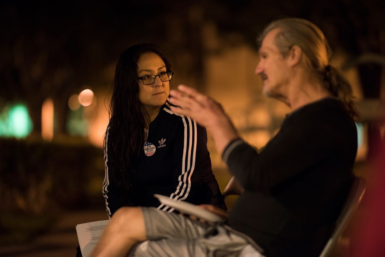 Daisy Ramirez, the ACLU's Orange County jail project coordinator, talks to Greg Compher, 58, about registering to vote and his rights.